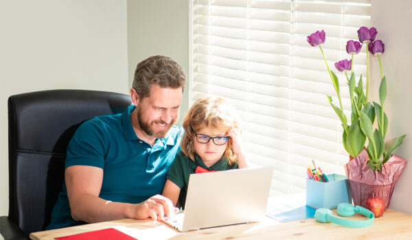 Banner of teacher and pupil school boy with laptop at home, back to school. father and son in eyewear use computer at home. family blog. nerd boy.